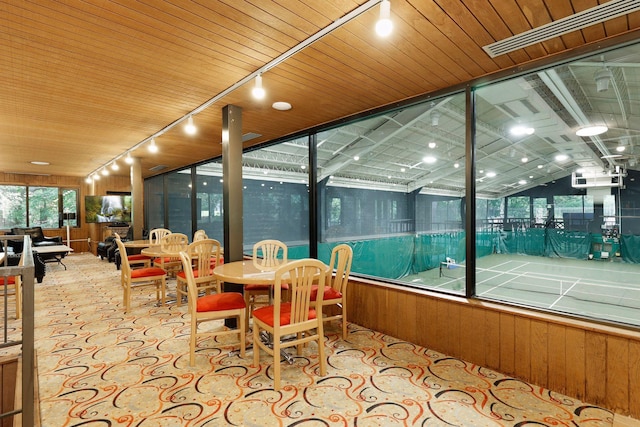 sunroom with wood ceiling and rail lighting