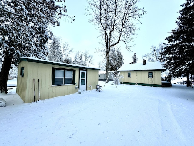 view of snow covered rear of property