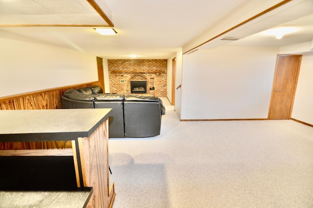 carpeted living room with wood walls