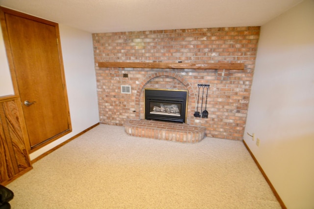 unfurnished living room with a fireplace and carpet floors