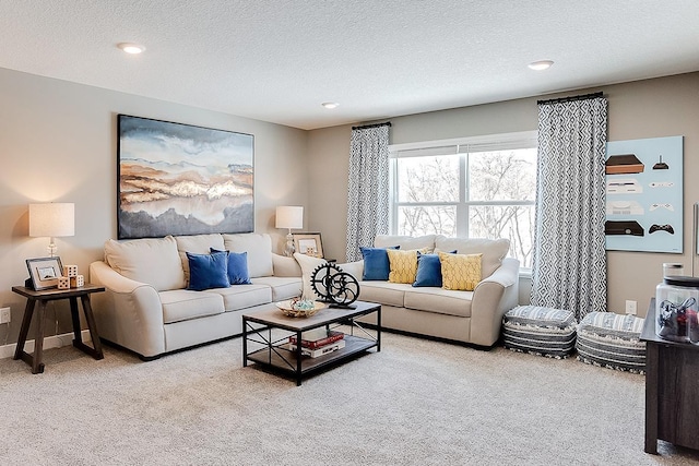 carpeted living room featuring a textured ceiling