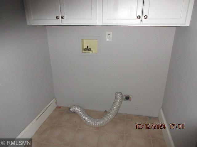 washroom featuring cabinets, washer hookup, electric dryer hookup, and light tile patterned flooring