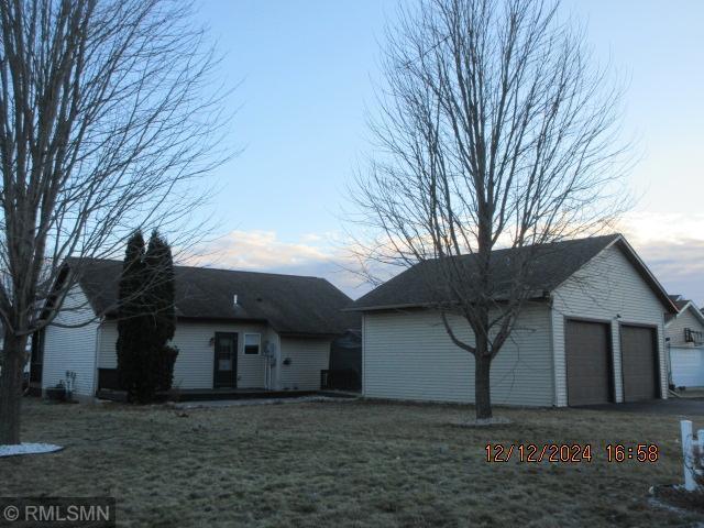 exterior space featuring a garage and a front lawn