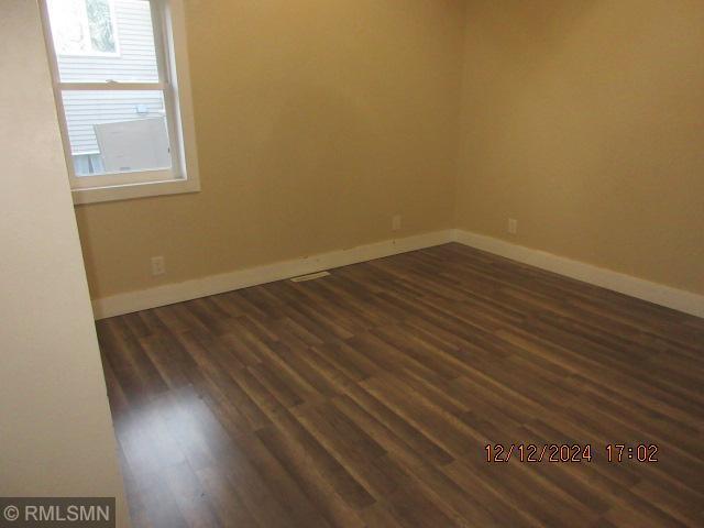 empty room featuring dark hardwood / wood-style floors