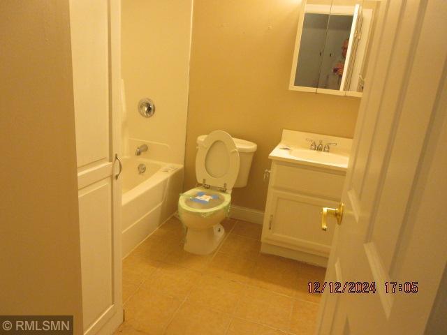 full bathroom with tile patterned floors, shower / bathing tub combination, vanity, and toilet