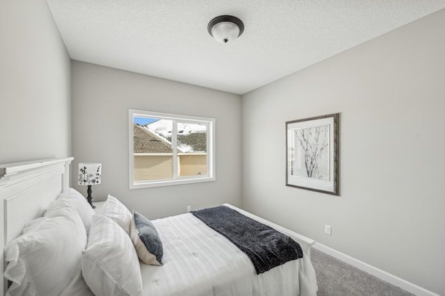 carpeted bedroom featuring a textured ceiling