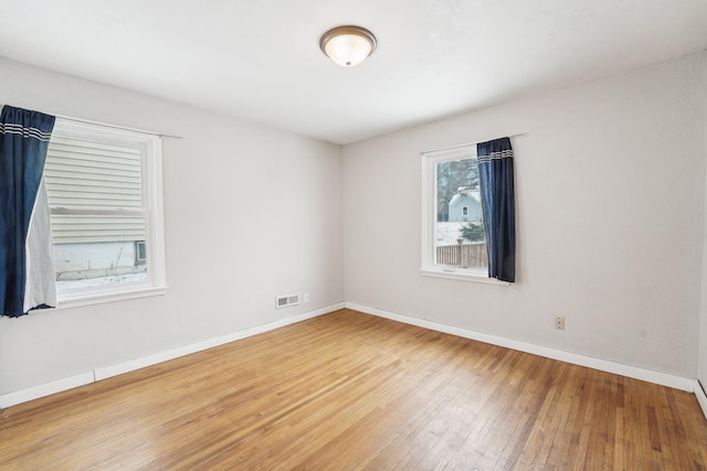 empty room with hardwood / wood-style flooring