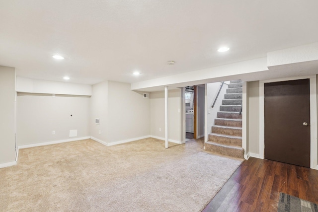 basement with washer / clothes dryer and dark hardwood / wood-style flooring