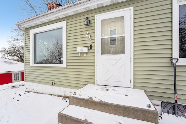 view of snow covered property entrance