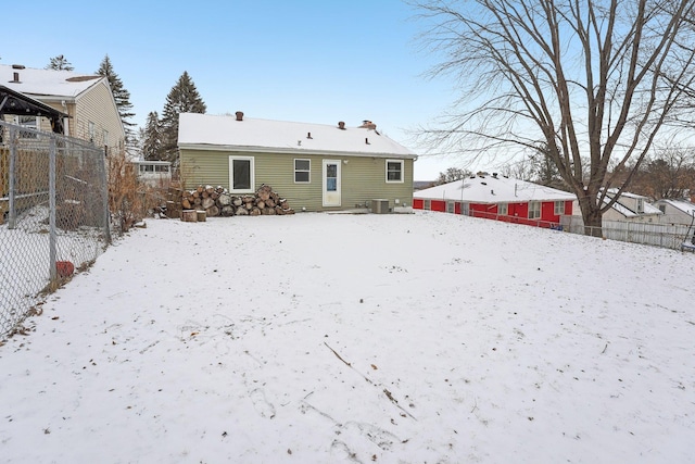 snow covered property with cooling unit