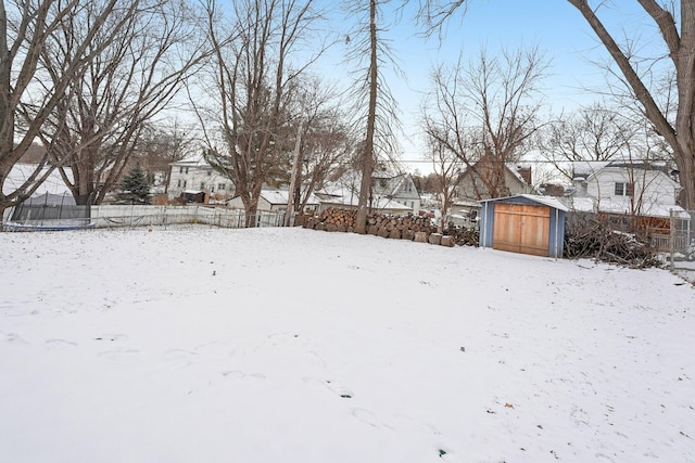 snowy yard with a storage unit