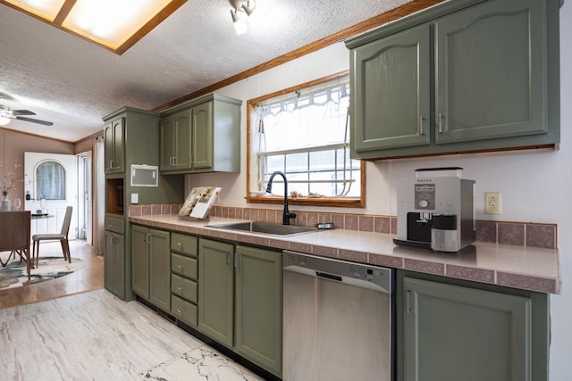 kitchen featuring a textured ceiling, crown molding, sink, dishwasher, and green cabinets