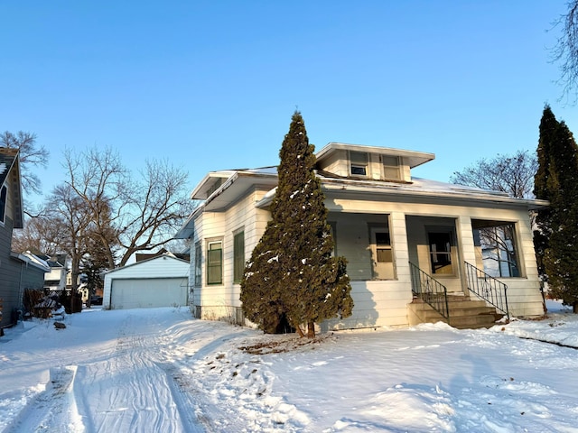 view of front of home with a garage and an outdoor structure