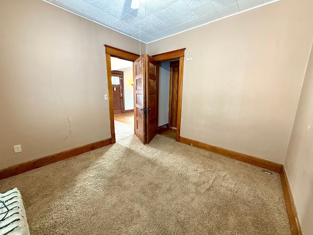 empty room with light carpet and ceiling fan