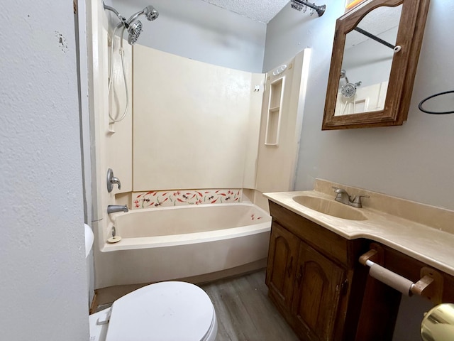 full bathroom with vanity, wood-type flooring, a textured ceiling, and tub / shower combination