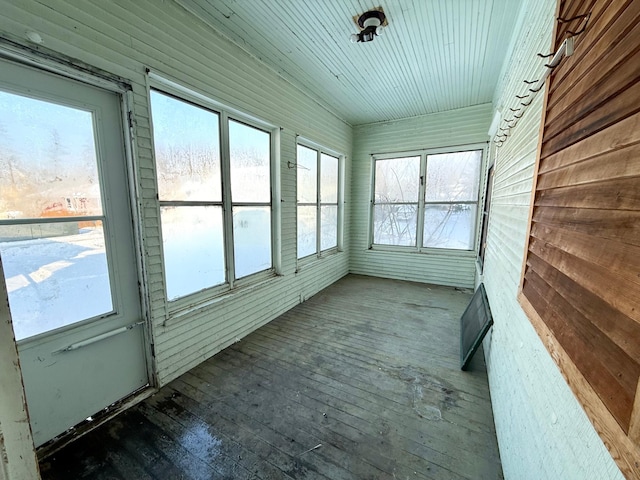 unfurnished sunroom featuring vaulted ceiling