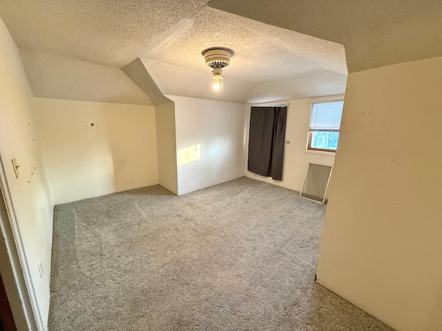 carpeted spare room featuring a textured ceiling