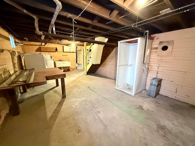 basement with wood walls and sink