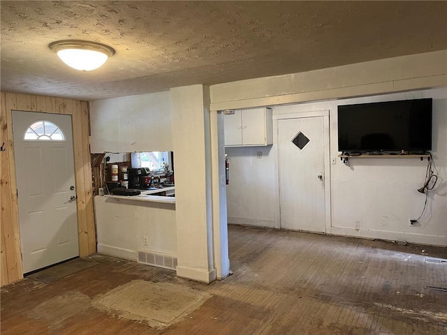 entryway featuring hardwood / wood-style floors and a textured ceiling