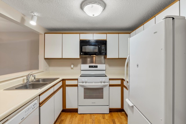 kitchen with a textured ceiling, white appliances, sink, white cabinets, and light hardwood / wood-style floors