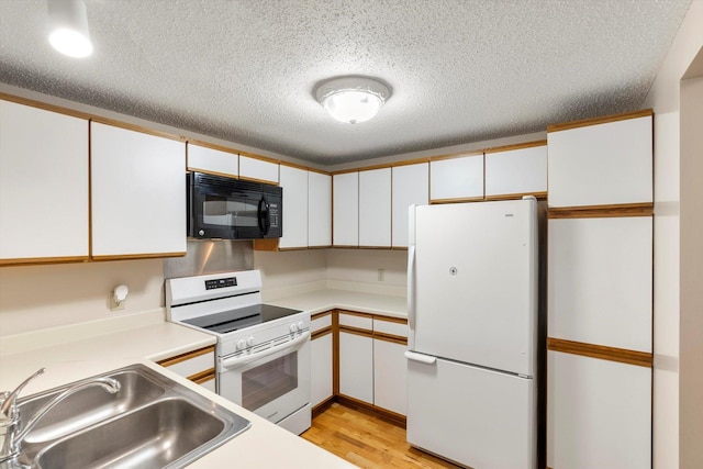 kitchen featuring white cabinets, white appliances, and sink