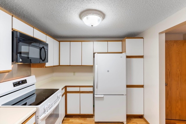 kitchen featuring a textured ceiling, white appliances, light hardwood / wood-style floors, and white cabinetry