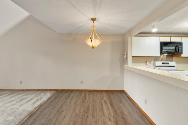 interior space featuring a textured ceiling and light wood-type flooring