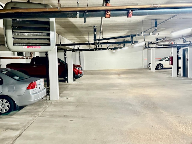 garage with a garage door opener and a carport