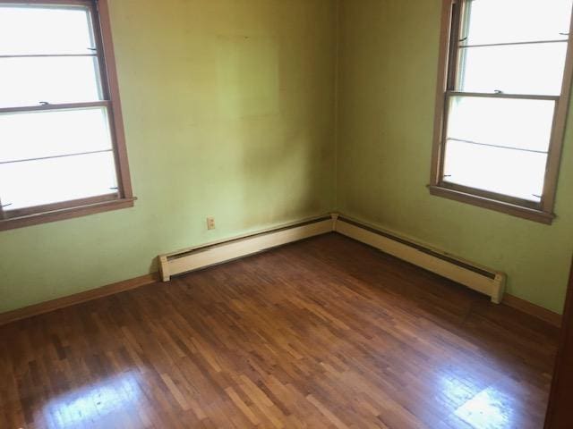 spare room featuring dark hardwood / wood-style flooring