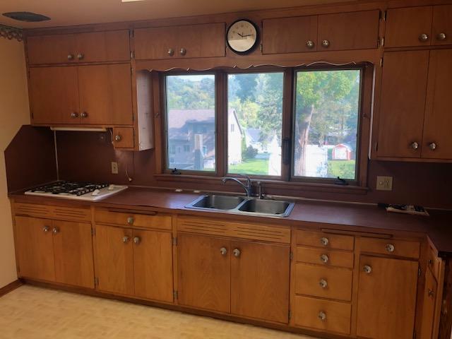 kitchen with white gas stovetop and sink