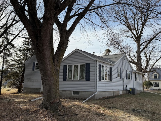 view of side of home featuring central AC