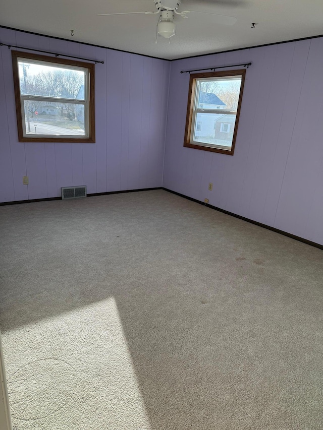 empty room with light carpet and ceiling fan