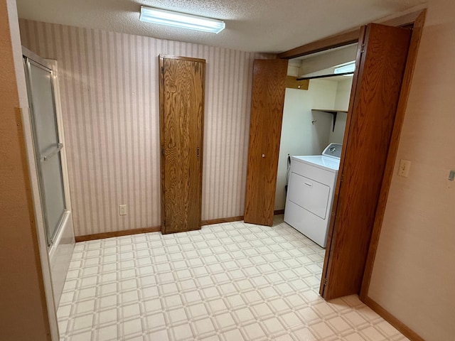 laundry area featuring a textured ceiling and washer / clothes dryer