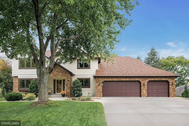 view of front of house with a garage and a front lawn