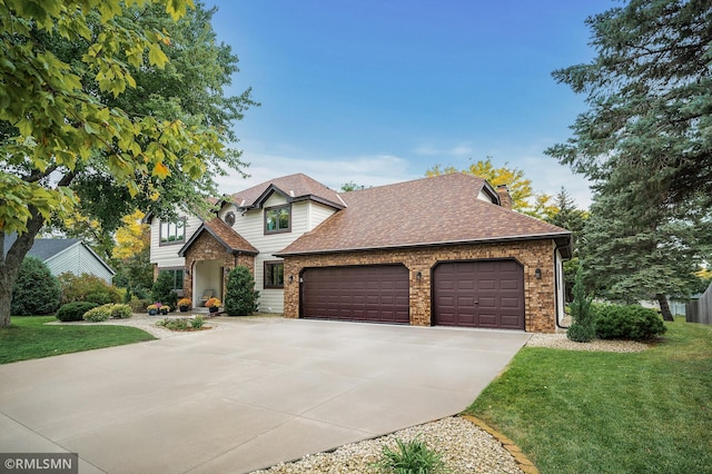 view of front of home with a front yard and a garage