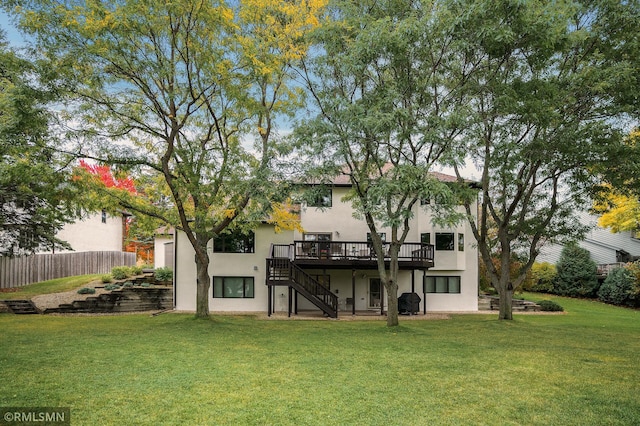 back of house with a lawn and a wooden deck