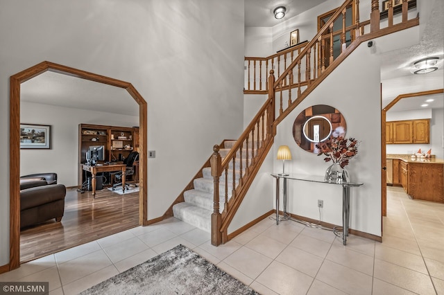 stairway with tile patterned floors