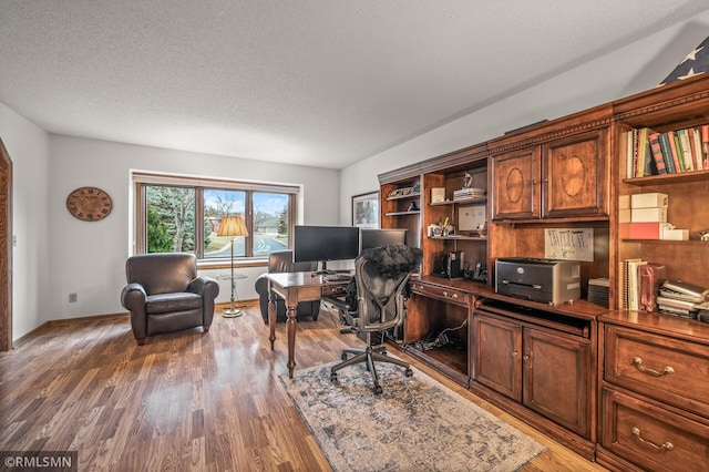 office featuring a textured ceiling and dark hardwood / wood-style floors