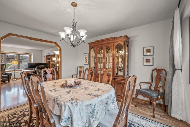 dining room with a chandelier and wood-type flooring