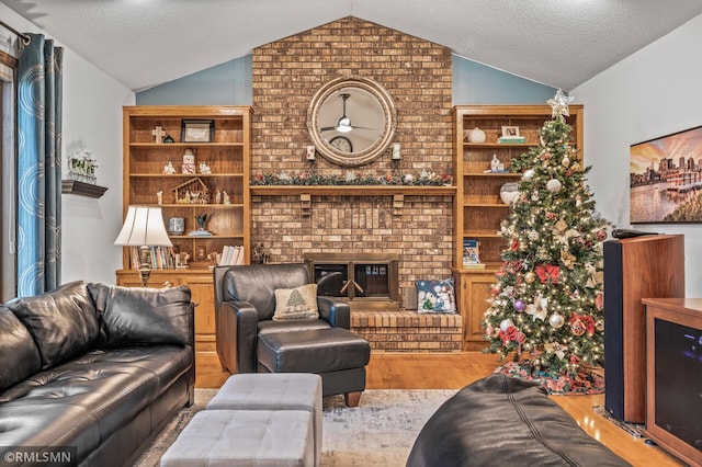 living room featuring a fireplace, light hardwood / wood-style floors, and lofted ceiling