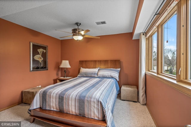 bedroom with light carpet, a textured ceiling, and ceiling fan