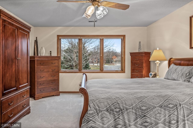 carpeted bedroom with a textured ceiling and ceiling fan