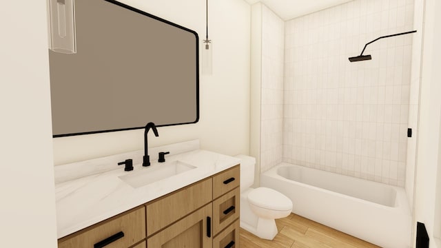 full bathroom featuring hardwood / wood-style floors, vanity, toilet, and tiled shower / bath