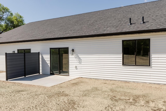 100 3rd Ave, Pelican Rapids, MN 56572 - rear view of house featuring a patio area and roof with shingles