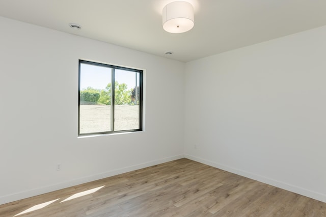 100 3rd Ave, Pelican Rapids, MN 56572 - empty room featuring light wood finished floors and a smoke detector