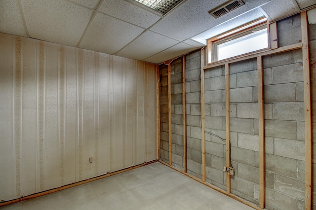 basement with a drop ceiling and visible vents