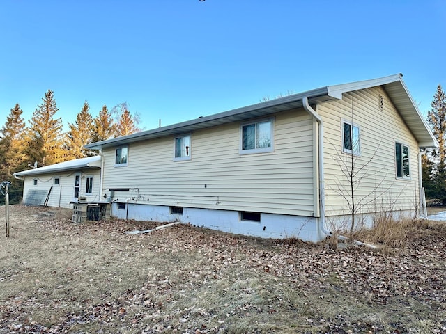 rear view of property with crawl space