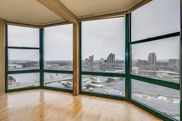 unfurnished sunroom with a water view and a wealth of natural light