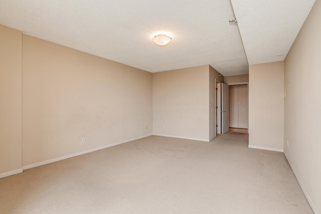 carpeted spare room featuring a textured ceiling