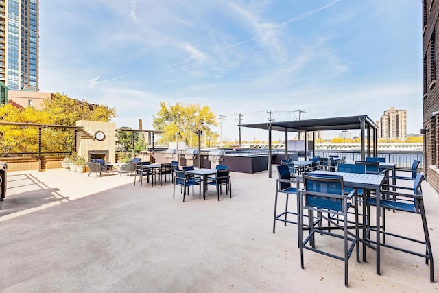 view of patio / terrace featuring an outdoor stone fireplace